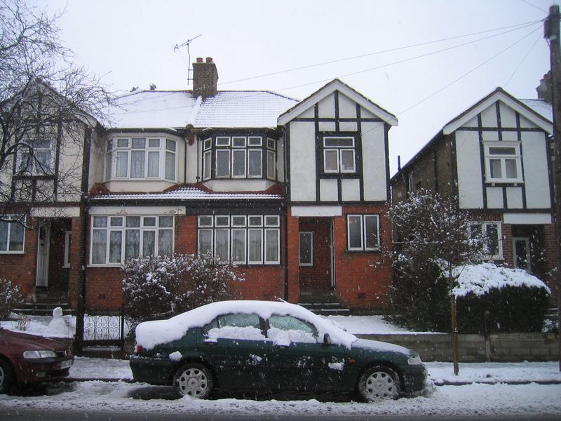 house & car under a dusting of snow